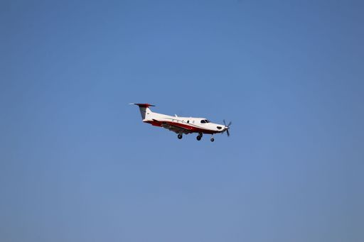 A side view of the Pilatus PC-12 helicopter landing at San Jose airport during reverse operations, arriving from Red Bluff