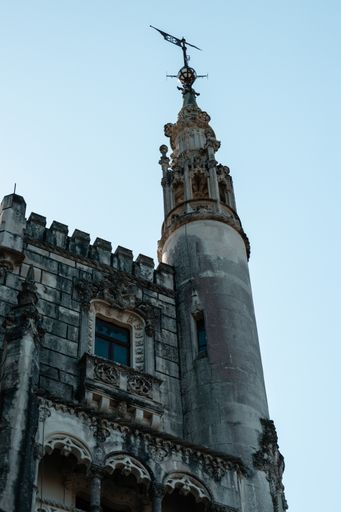 A vertical shot of the Palace of Quinta da Regaleira against a clear blue sky in Sintra