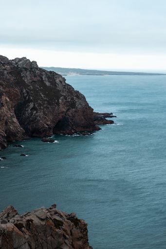 A mesmerizing view of Cabo da Roca over the sea water on a gloomy day in Lisbon, Portugal