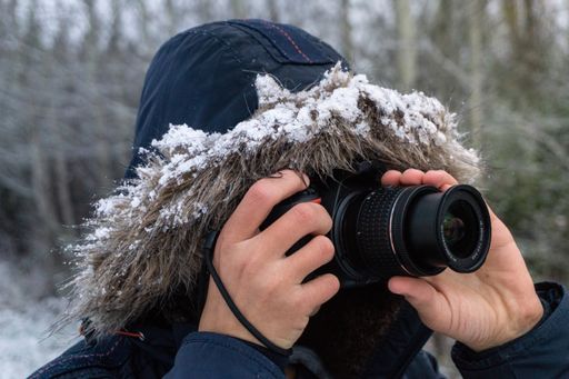 A person taking photos with a professional camera