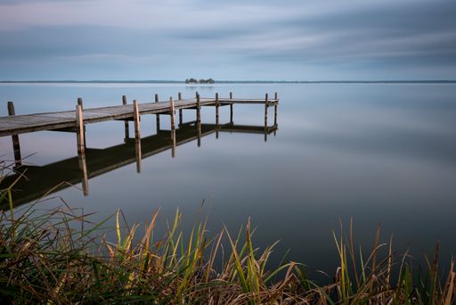 A wooden pier in Steinhuder Meer lake in Germany on during the early morning