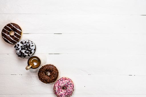 A closeup of the colorful donuts on white background with copy space.