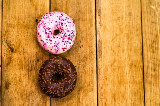 The glazed donuts and cookies on wooden table