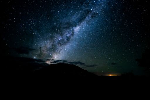 A breathtaking shot of the silhouettes of hills under a starry sky in the night - perfect for wallpapers