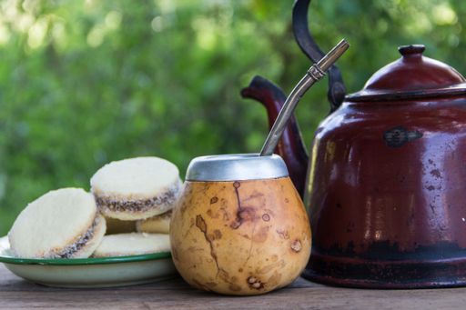 Mate and kettle with a plate of alfajores and yerba mate infusion in the Argentine countryside