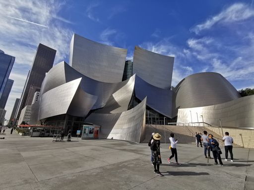 The famous Walt Disney concert hall in Los Angeles against a blue cloudy sky on a sunny day