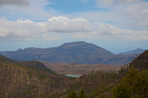 A mesmerizing view of Gran Canaria island with dense vegetation against cloudy sky on Canary Islands