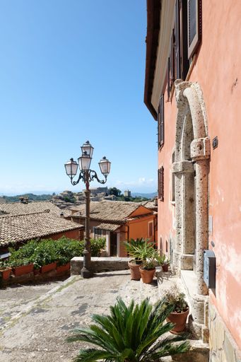 A narrow street among the houses of a small medieval town in Lazio.