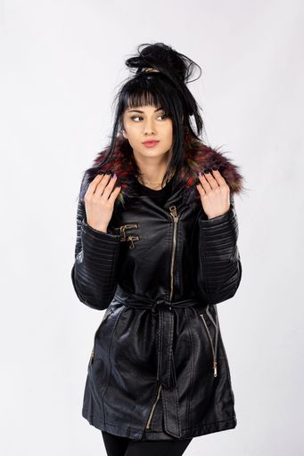 A vertical shot of a young Caucasian female in a warm coat posing on isolated white background