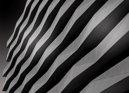 A greyscale shot of the facade of a modern building