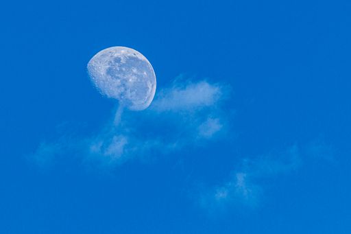 A beautiful shot of the moon on the blue sky