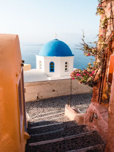 A vertical shot of beautiful buildings in Santorini island in the Aegean Sea, Cyclades, Greece
