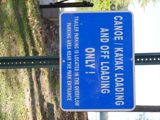 A vertical shot of a blue sign with the text 'canoe/kayak loading and off loading only'