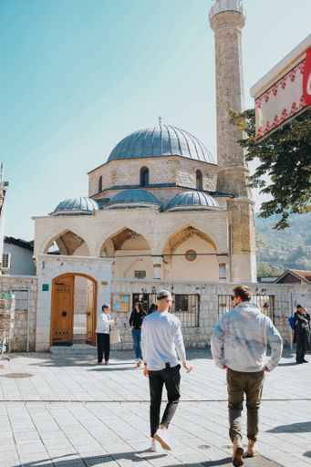 A vertical shot of tourists walking on Bascarsija square,