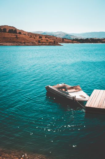 A vertical shot of a small boat at the pier
