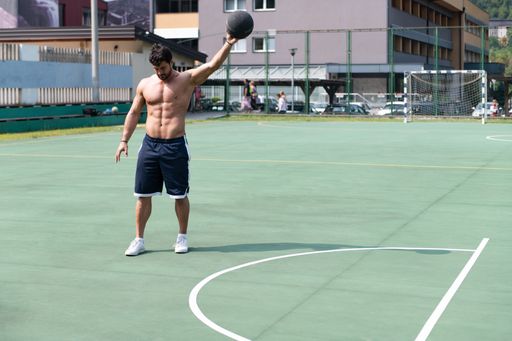 A bodybuilder practicing and posing for basketball and sports athlete concept