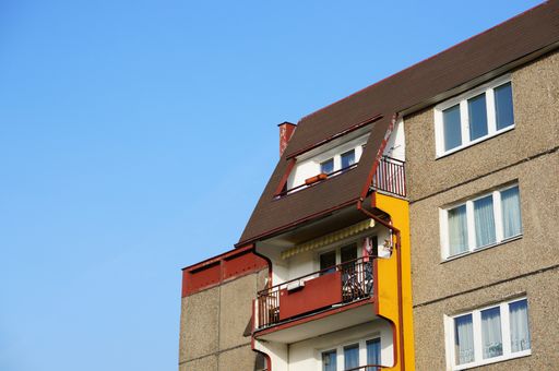 A low angle shot of an architectural building with a blue sky in the background