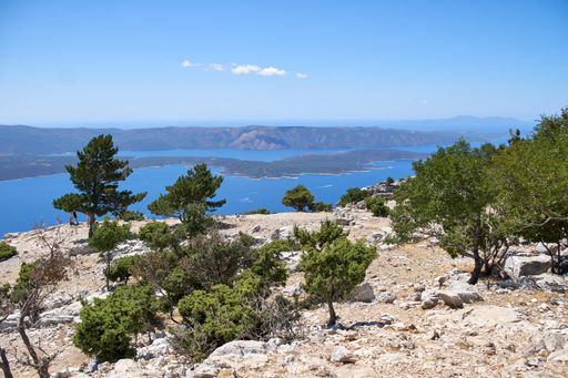 A scenic view of Zlatni Rat Beach in Bol, Croatia under a blue sky