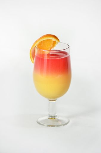 A vertical shot of a delicious Sex on The Beach cocktail with a white background