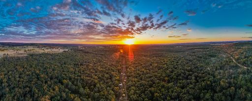 A panoramic shot of a bush land of Emmaville over a background of a beautiful sunset