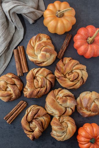 A vertical top view of delicious homemade pumpkin spice cinnamon roll buns