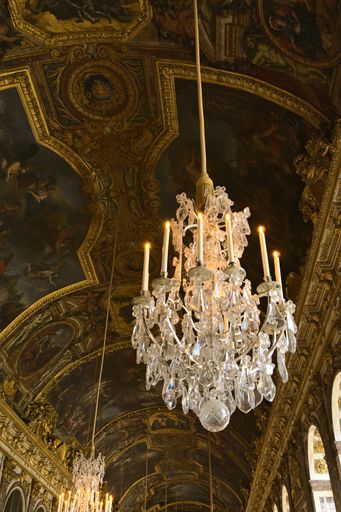 A low angle shot of chandeliers on the ceilings in Palace of Versailles, Paris, France