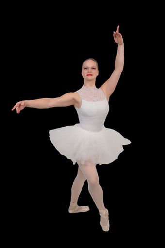 A professional woman ballerina dancing on a black background