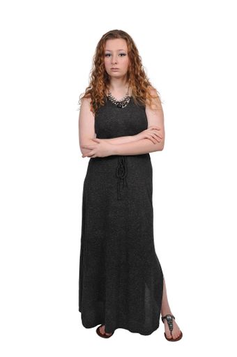 A vertical shot of a beautiful white woman wearing a dress and posing on a white background