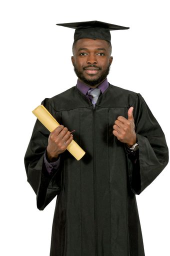 A vertical shot of an African American man with a graduation costume