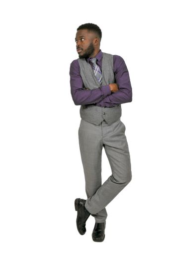 A vertical shot of an African American man with a white background