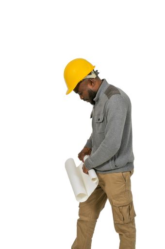 A vertical shot of an African American man with a construction worker hat