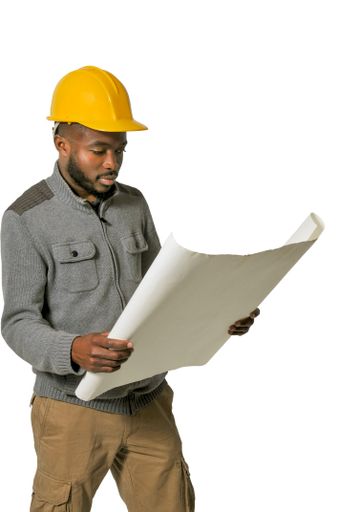 A vertical shot of an African American man with a construction worker hat
