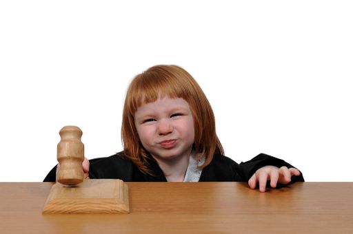 A white ginger girl with a hammer appearing as the superior Court Judge