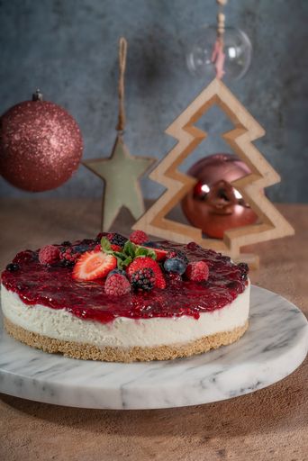 A vertical shot of a cake and Christmas decoration