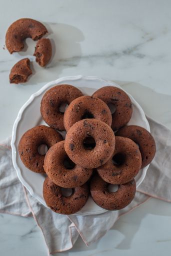 A vertical top view of delicious donuts with chocolate