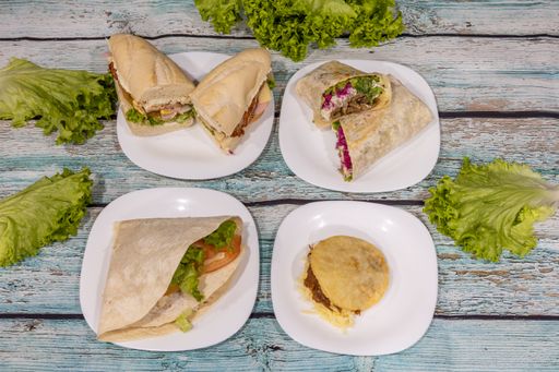 A top view of various types of sandwiches on plates