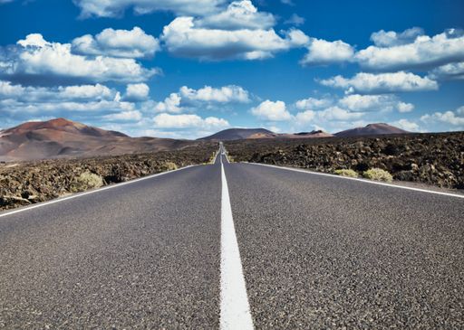 public road to the timanfaya national park in Lanzarote on a sunny day with view to the volcanic rocks