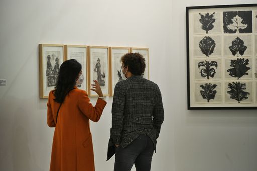 A back view of young people having a conversation during the "Artissima" contemporary art fair in Turin