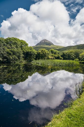 A vertical view of the Connemara National Park in Mweelin Ireland under a cloudy blue sky