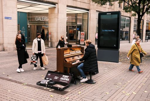A pianist performing in Hohe street in Cologne, Germany