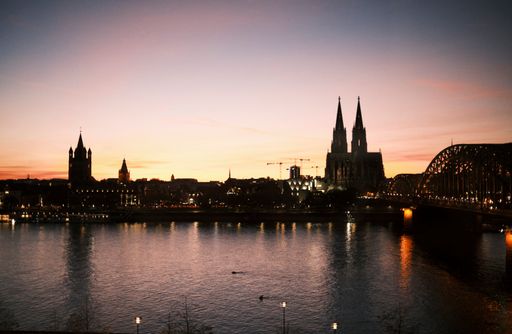 The sunset sky over the Cologne Cathedral and the Hohenzollern Bridge