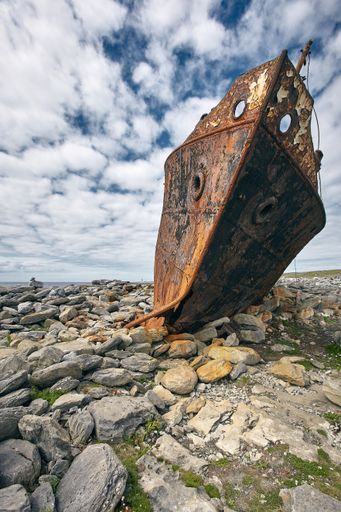 A vertical shot of a rusty carcass of the Plassy ship in Aran Islands, Ireland