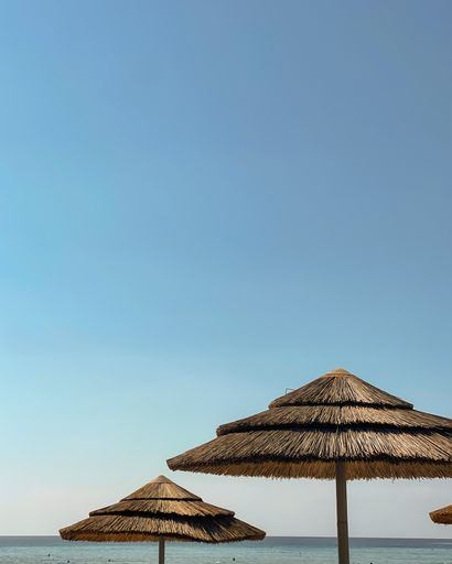 A vertical shot of a beach with umbrellas