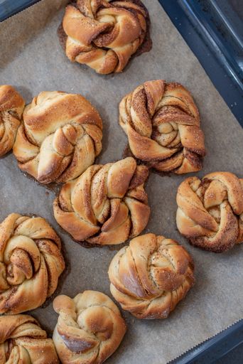 A vertical top view of delicious homemade pumpkin spice cinnamon roll buns