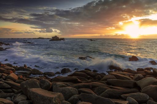 A beautiful scenery of rocky seashore and a sea during the sunset