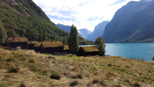 A beautiful shot of huts and a landscape under the cloudy skies