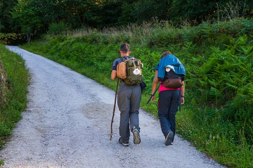 A young couple on pilgrimage to Santiago de Compostela with their backpacks, Spain