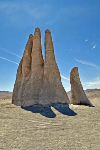 A vertical shot of sculpture hand located in the Atacama Desert in Chile
