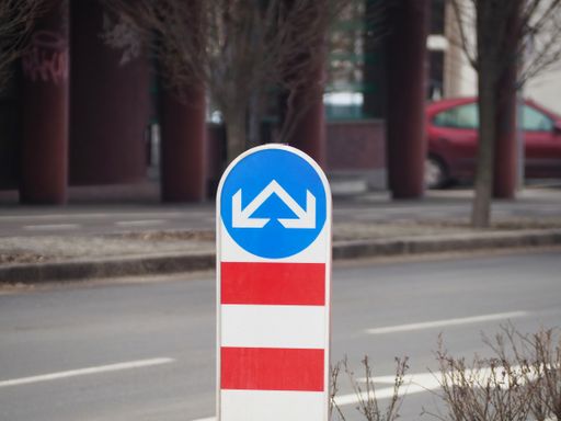 A closeup shot of a traffic sign "detour obstacle" in the street on a cold gloomy day