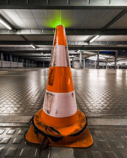 A closeup of a traffic cone in the parking, Aachen, Germany